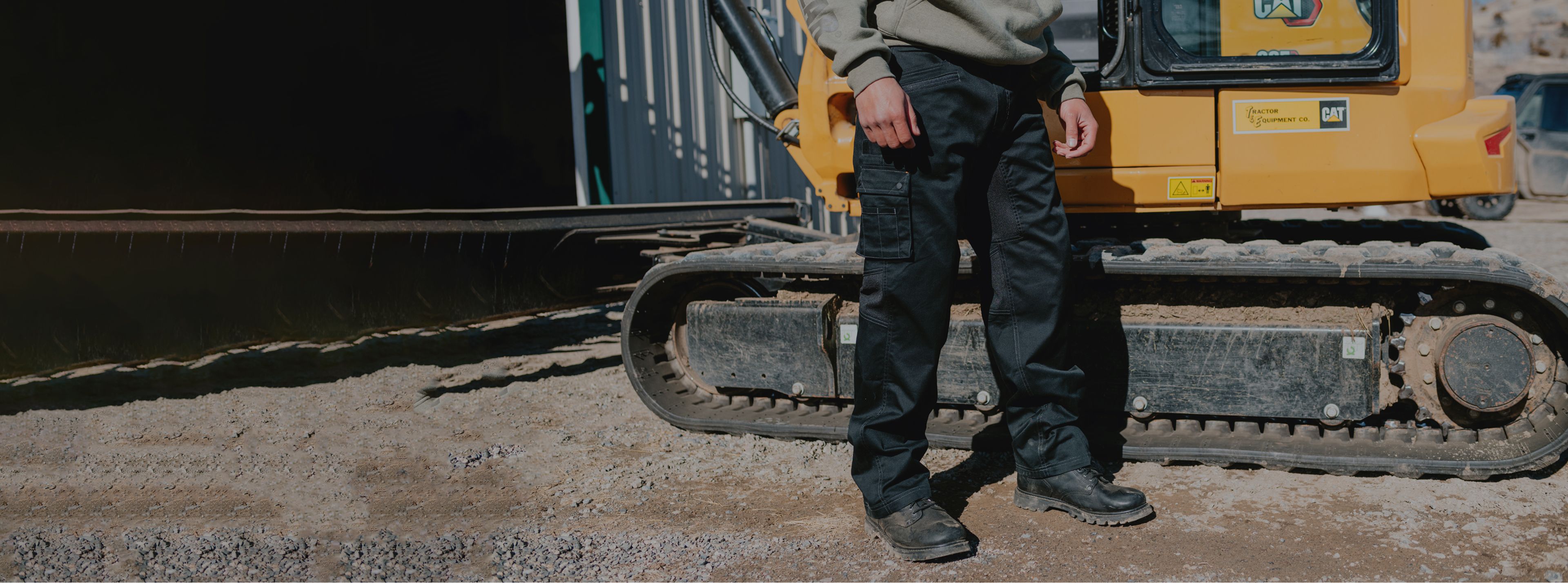 Standing beside tracked equipment.