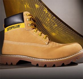 Tan boot with prominent black-on-yellow Caterpillar logo on side of ankle.